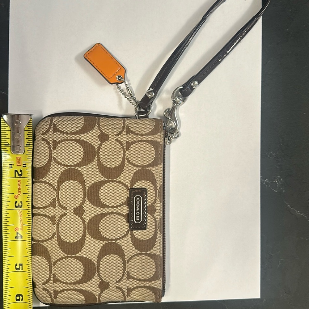 COACH wristlet 6x4 inches in size.  Inside is in great condition.  Tan/brown
